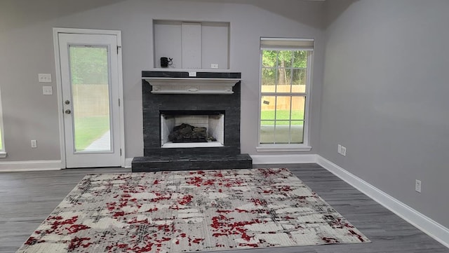 138 Breezeway Dr, Brookeland, TX 75931 - living area with baseboards, dark wood-style floors, and a fireplace with raised hearth