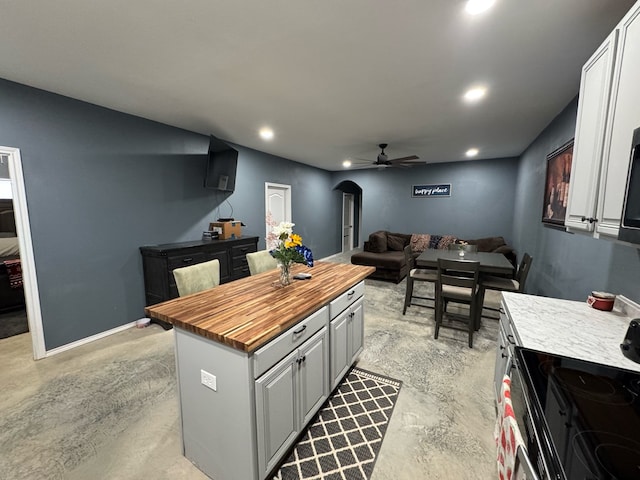 0103 Old Fm 705, Broaddus, TX 75979 - kitchen featuring wooden counters, finished concrete flooring, a ceiling fan, electric stove, and recessed lighting