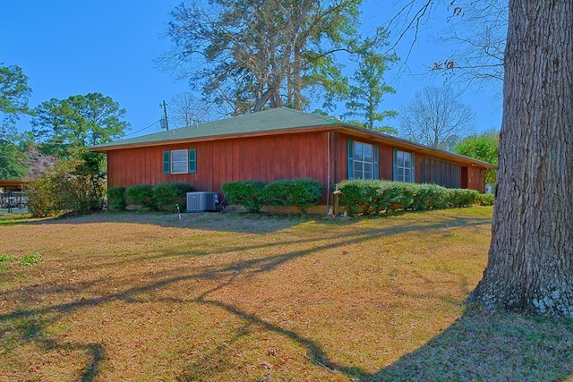 view of home's exterior featuring cooling unit and a yard