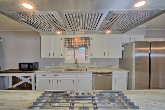 kitchen featuring a sink, white cabinets, ornamental molding, appliances with stainless steel finishes, and light stone countertops