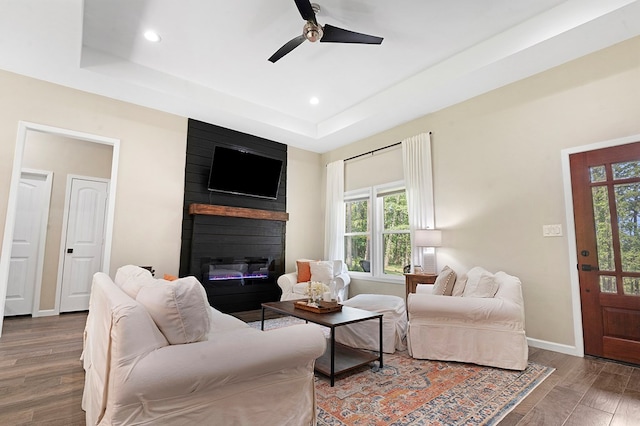 155 Sweetbriar Ct, Brookeland, TX 75931 - living area featuring a large fireplace, a ceiling fan, a raised ceiling, wood finished floors, and recessed lighting