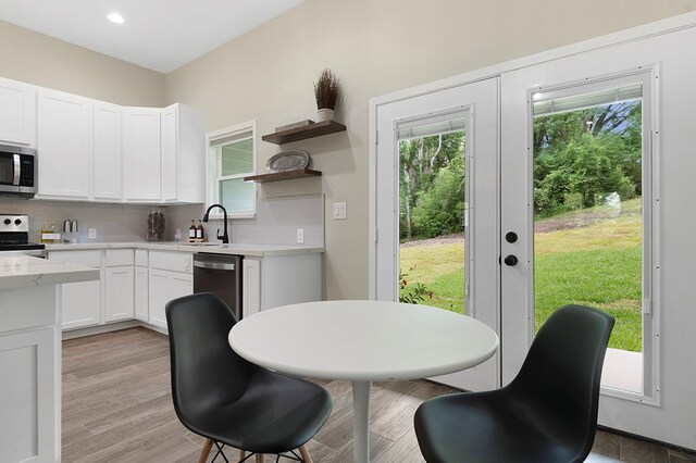 155 Sweetbriar Ct, Brookeland, TX 75931 - kitchen with appliances with stainless steel finishes, white cabinets, backsplash, open shelves, and recessed lighting