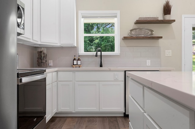 155 Sweetbriar Ct, Brookeland, TX 75931 - kitchen featuring range, open shelves, white cabinetry, and tasteful backsplash