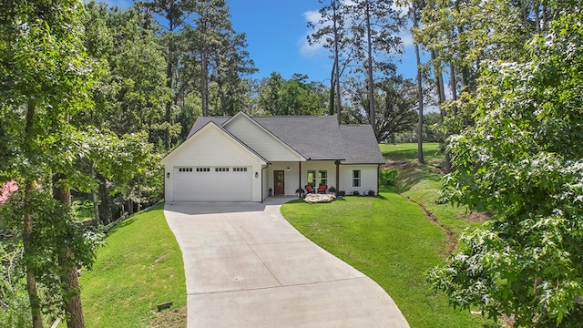 155 Sweetbriar Ct, Brookeland, TX 75931 - view of front of house with driveway, an attached garage, a front lawn, view of wooded area, and covered porch