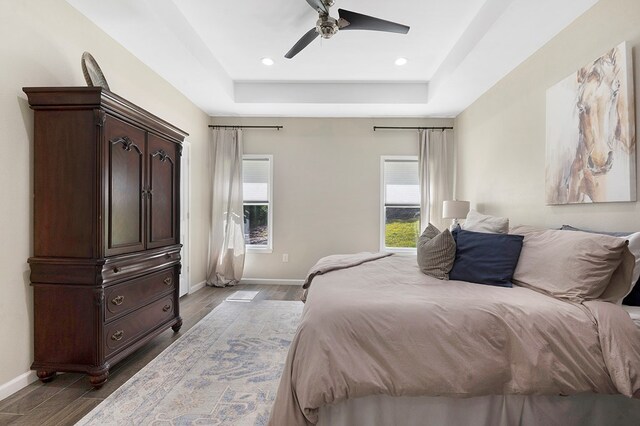 155 Sweetbriar Ct, Brookeland, TX 75931 - bedroom with a tray ceiling, dark wood-style flooring, a ceiling fan, and recessed lighting