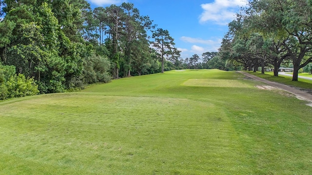 155 Sweetbriar Ct, Brookeland, TX 75931 - view of community featuring view of golf course, view of wooded area, and a yard