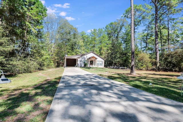 view of front of property with a garage and a front lawn