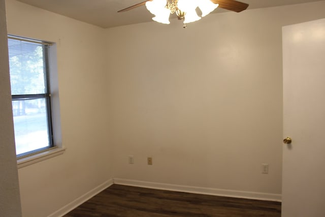 unfurnished room with a ceiling fan, dark wood-style flooring, and baseboards