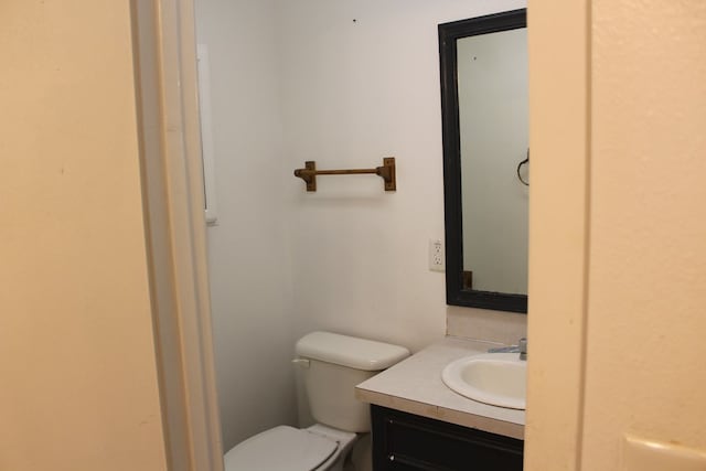 bathroom with toilet and vanity