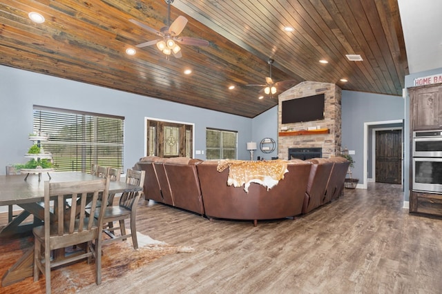737 Martin Cochran Rd, Huntington, TX 75949 - living area featuring a ceiling fan, wood ceiling, a stone fireplace, wood finished floors, and vaulted ceiling