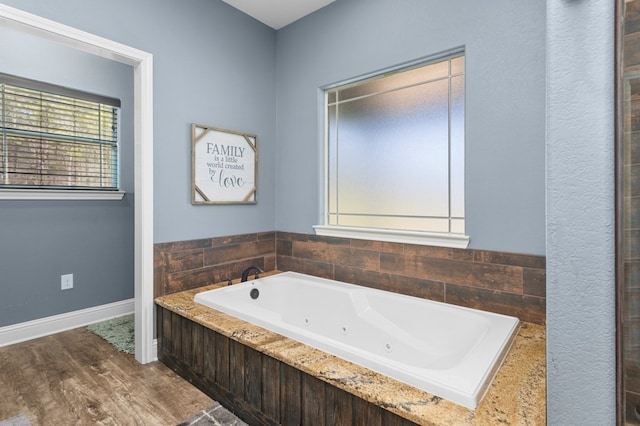 737 Martin Cochran Rd, Huntington, TX 75949 - bathroom with a whirlpool tub and wood finished floors