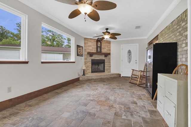 living room featuring ceiling fan, a large fireplace, and crown molding