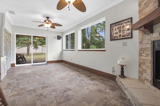 unfurnished living room with a wealth of natural light, ceiling fan, and ornamental molding