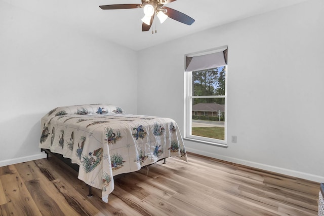 bedroom with ceiling fan and wood-type flooring