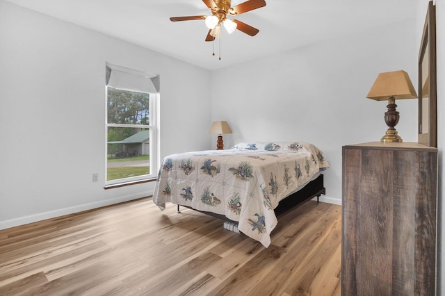 bedroom with ceiling fan and light hardwood / wood-style flooring