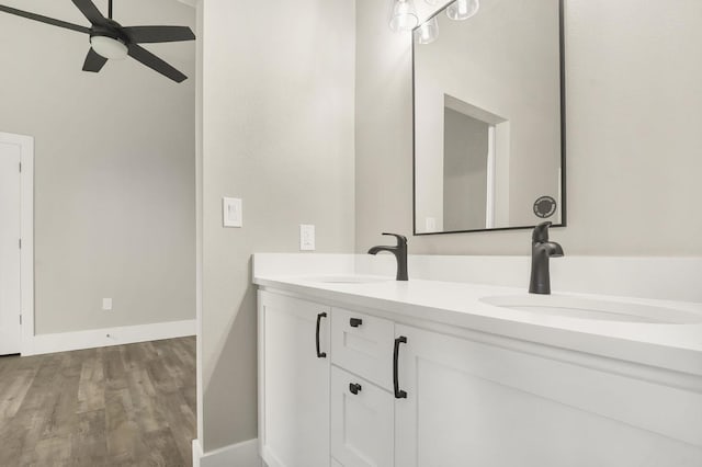 bathroom with ceiling fan, hardwood / wood-style floors, and vanity