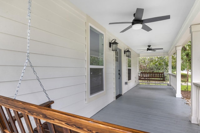 deck featuring covered porch and ceiling fan