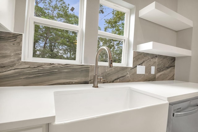 room details featuring dishwasher, decorative backsplash, and sink