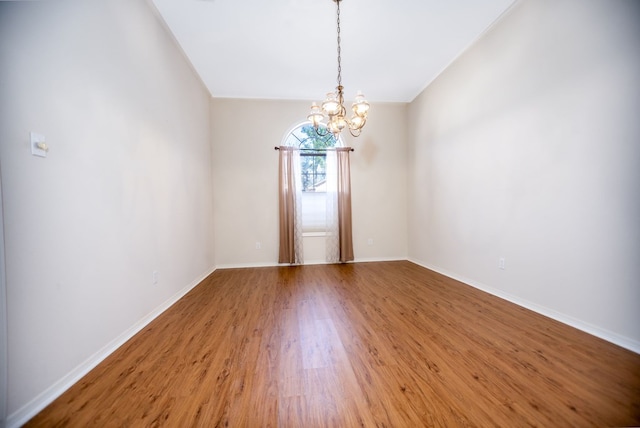 3712 Ashbury Ln, Nacogdoches, TX 75965 - spare room featuring a chandelier, wood finished floors, and baseboards