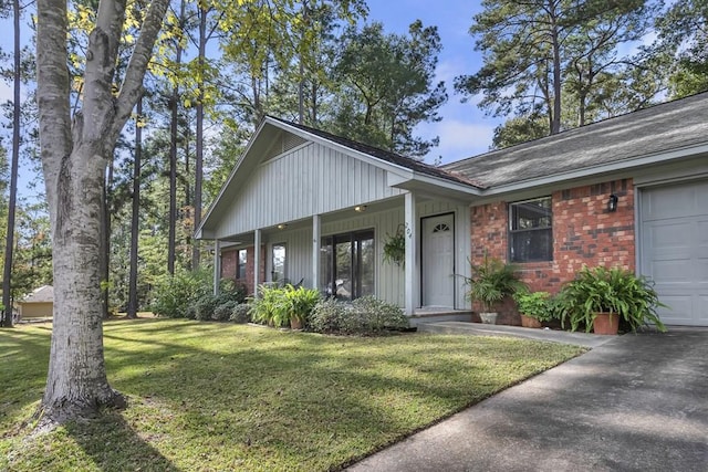 view of front facade featuring covered porch, a garage, and a front lawn