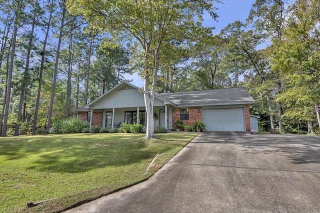 single story home featuring covered porch, a garage, and a front lawn