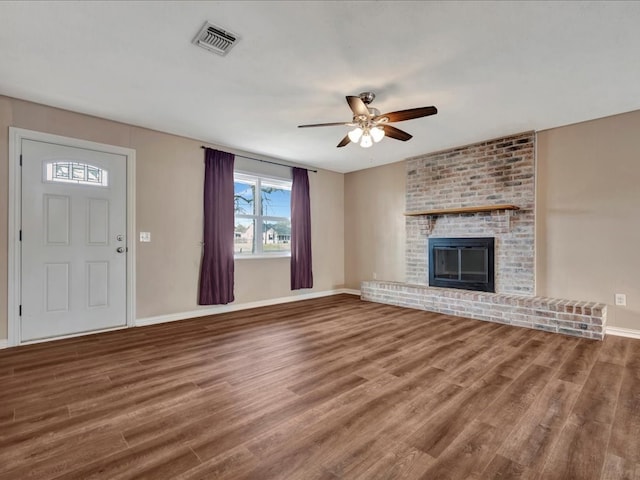 unfurnished living room with visible vents, ceiling fan, and wood finished floors