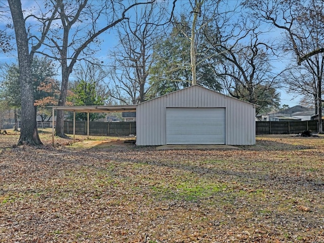 view of outdoor structure featuring an outbuilding and fence