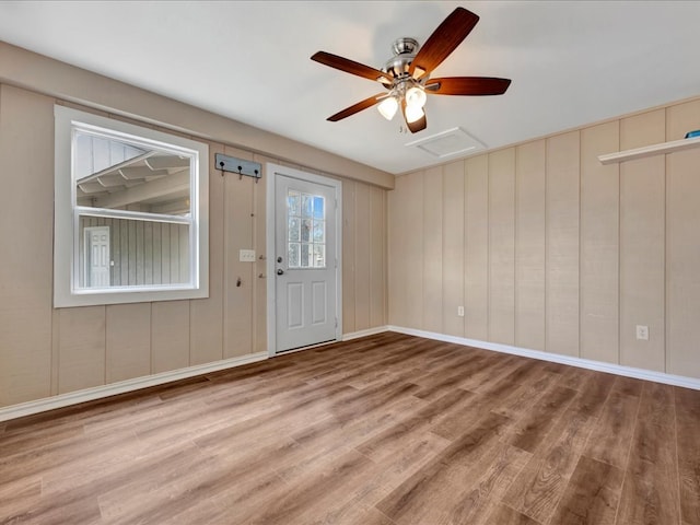 foyer with ceiling fan, baseboards, and wood finished floors