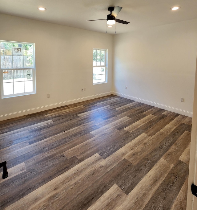 unfurnished room featuring ceiling fan and dark wood-type flooring