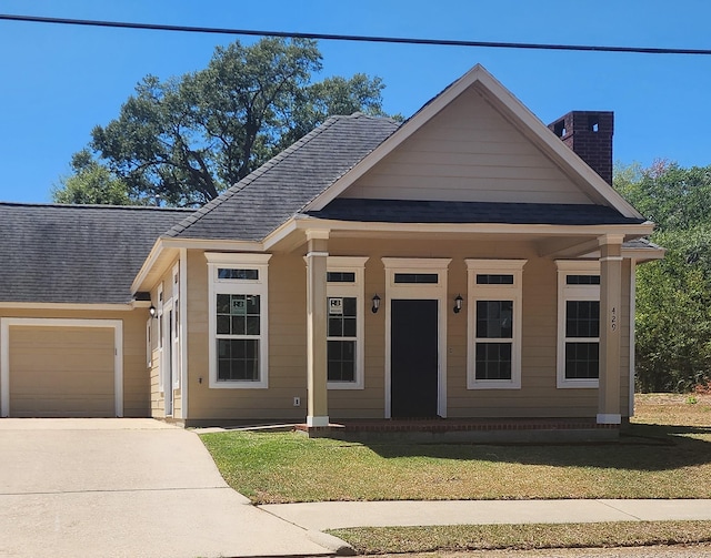 view of front facade with covered porch, a garage, central air condition unit, and a front yard