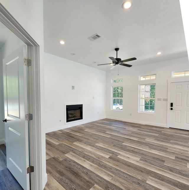 unfurnished living room featuring ceiling fan and wood-type flooring