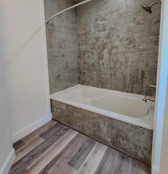 bathroom featuring hardwood / wood-style floors and tiled shower / bath combo