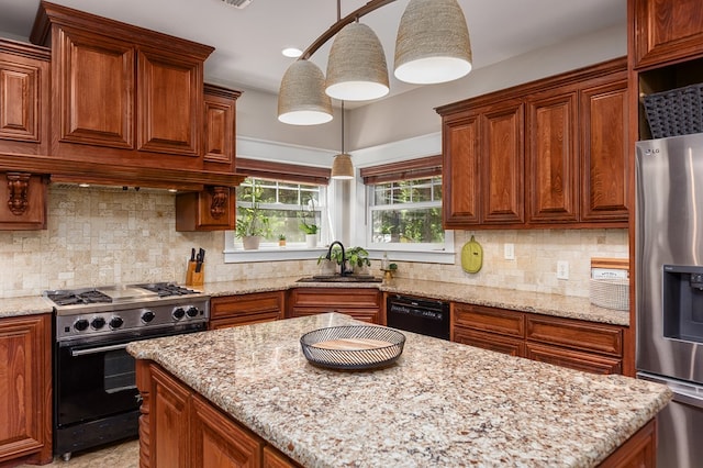 kitchen with light stone countertops, sink, backsplash, decorative light fixtures, and black appliances