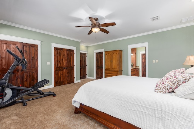 carpeted bedroom with ceiling fan, crown molding, and ensuite bathroom