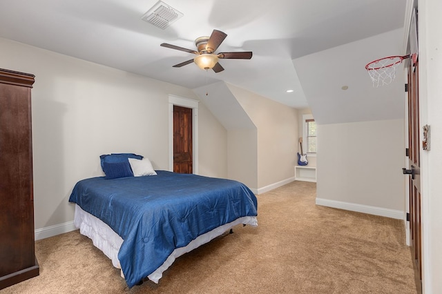 bedroom with ceiling fan, light colored carpet, and vaulted ceiling