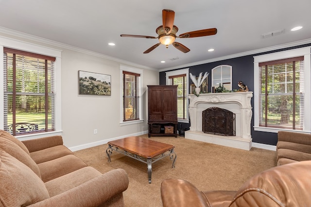 living room with light carpet, a wealth of natural light, ornamental molding, and ceiling fan