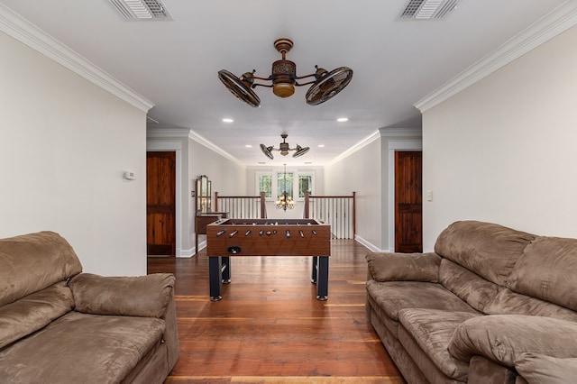 game room featuring hardwood / wood-style flooring, ceiling fan with notable chandelier, and crown molding