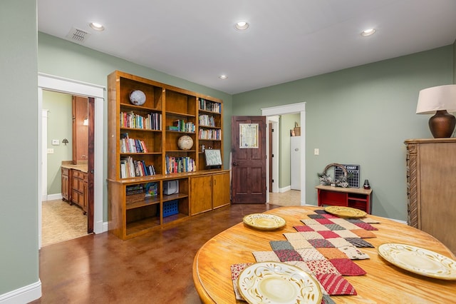 bedroom with dark carpet and connected bathroom