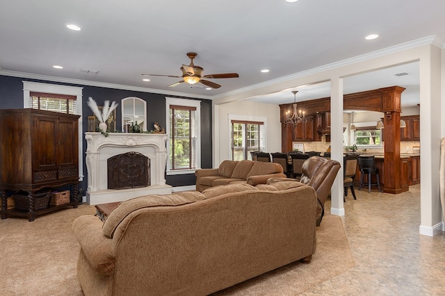 living room with crown molding and ceiling fan with notable chandelier