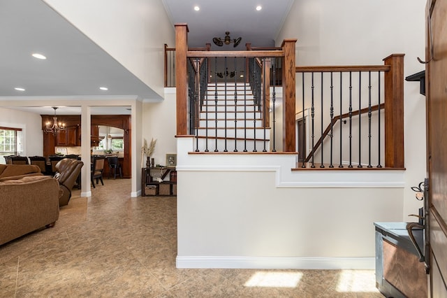 stairway featuring a notable chandelier and crown molding