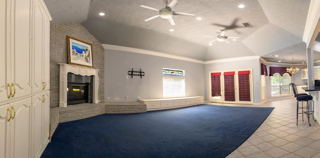 unfurnished living room with visible vents, a brick fireplace, ceiling fan with notable chandelier, tile patterned floors, and lofted ceiling