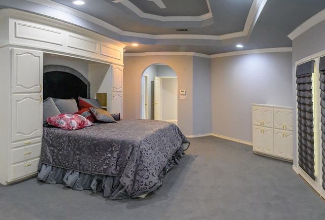 carpeted bedroom featuring arched walkways, visible vents, crown molding, and a raised ceiling
