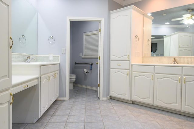 bathroom with a ceiling fan, toilet, a sink, tile patterned floors, and decorative backsplash