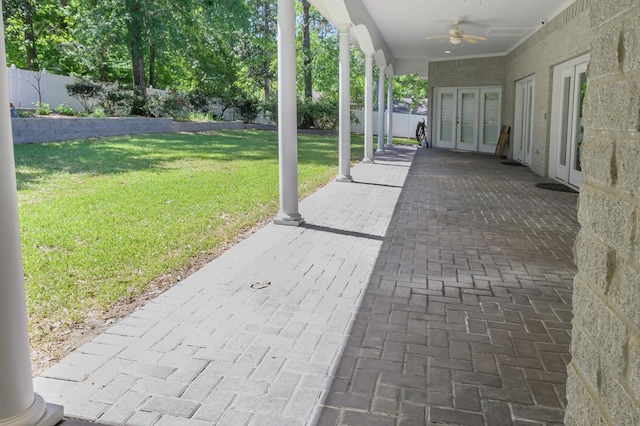 view of patio with french doors, ceiling fan, and fence