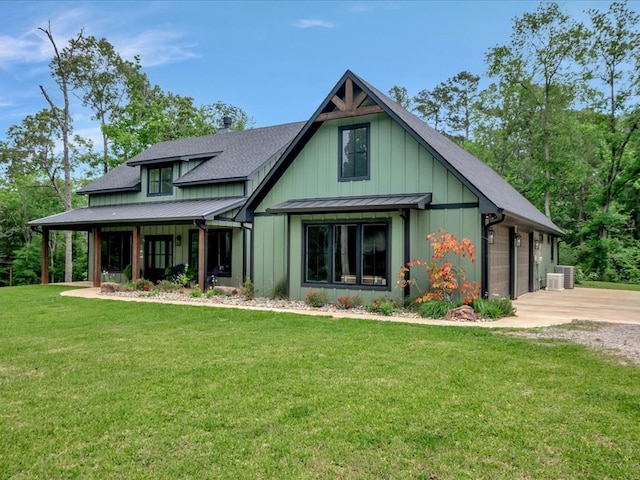craftsman-style house featuring a standing seam roof, a front lawn, driveway, and metal roof