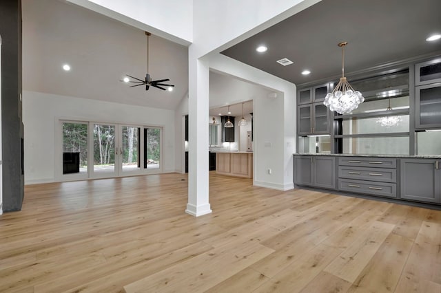 unfurnished living room featuring visible vents, baseboards, light wood-type flooring, recessed lighting, and a chandelier