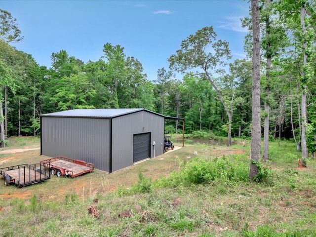 view of pole building with a wooded view
