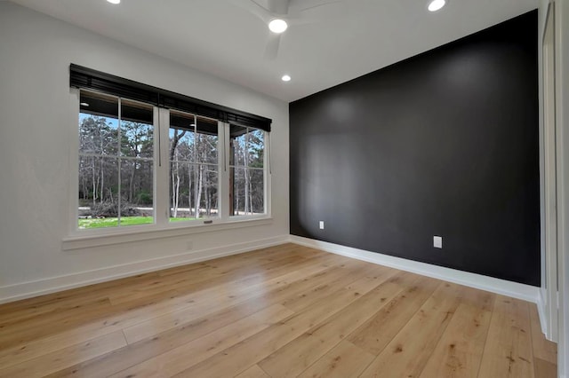 empty room with recessed lighting, ceiling fan, baseboards, and light wood-type flooring