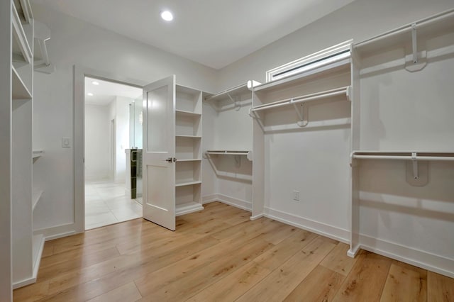 spacious closet featuring light wood-style flooring