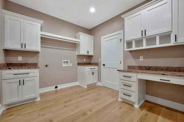 clothes washing area with baseboards, cabinet space, hookup for an electric dryer, light wood-style flooring, and washer hookup